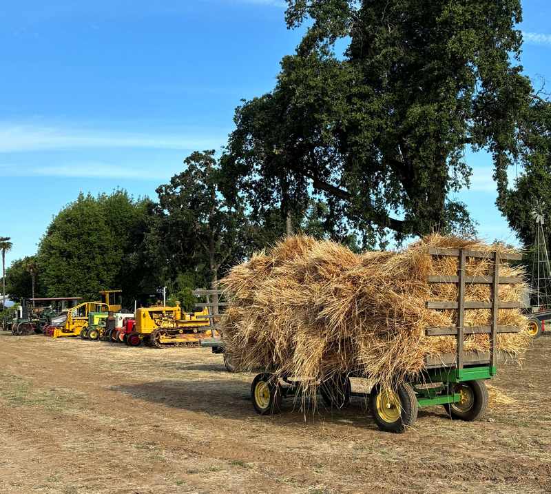 stacked hay and waiting machines